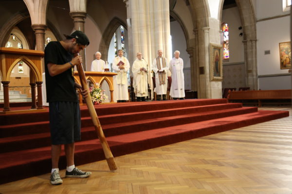 Brent plays didgeridoo at Jesuit Social Services' 40 years Mass